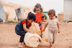 https://unsplash.com/photos/a-group-of-children-playing-with-a-large-drum-g5zl6jRsR7I